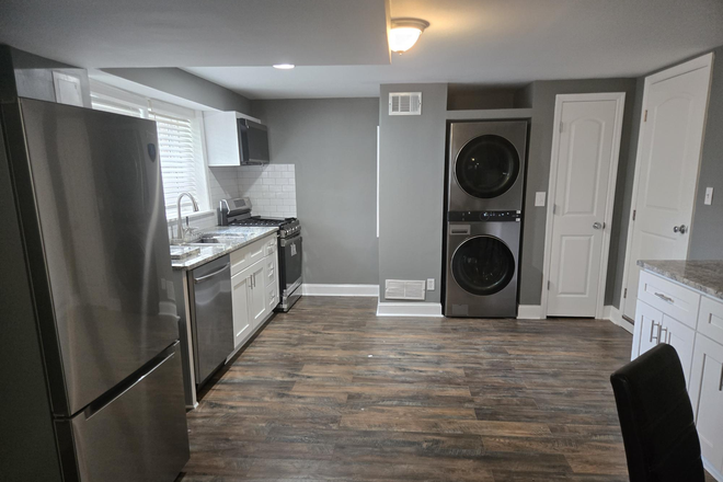 Kitchen and living room - One Bedroom Basement Apartment with New Kitchen Minutes from Campus (utilities included)