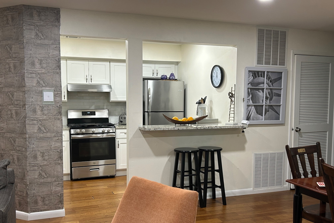 View of Kitchen from main living area ( large living space, tv, seating and  fully furnished patio w/ lighting + storage (not pictured) - Furnished 2BR/2 bath condo-Acadia Ct-Princeton