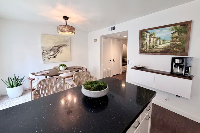 Open-concept kitchen and dining area. - Student/Staff- Fully Furnished 3BR Townhome Near Chapman University w/ Utilities and Parking