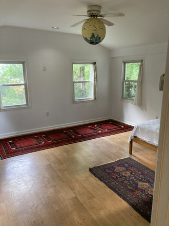 Living room. 4 windows total. Front windows look onto back garden - 1 Bed 1 Bath Apartment