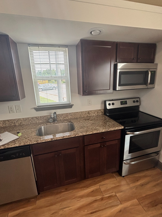 Tiny home kitchen. - SKIP THE WAITLIST! 1x1 Tiny Home for Re-Let at The Pier
