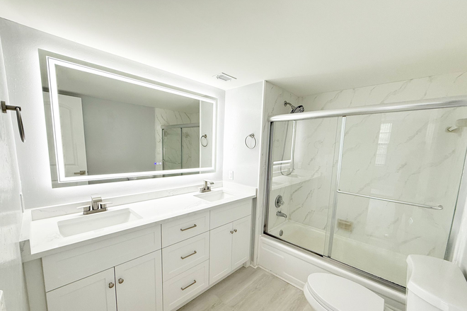 Master bathroom with bathtub shower and double vanity sinks - Remodeled Corner 2BR/2BA Near NSU – Only $1,000 Deposit! Condo