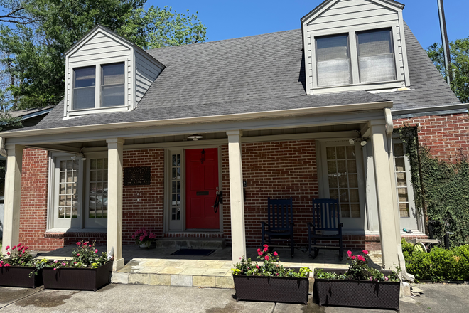 Charming cottage exterior with front porch & rocking chairs overlooking rose bush planters perfect for waiting to meet friends - Rice Village Cottage Duplex - 1 upstairs bedroom available in main house 2 bedroom unit