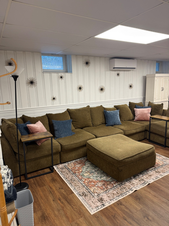 Living room area with large sectional couch. - Fully Furnished Lower Level Apartment with Amazing Amenities.