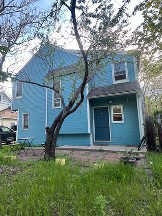 Front view of the house and patio area. - Goss Grove Apartment