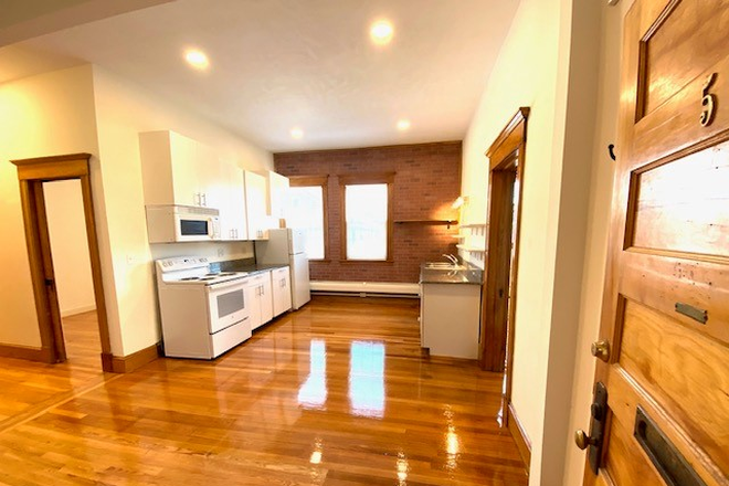 Kitchen and living area - Avail 7/1/26 Four Bedroom, two full bathrooms, hardwood floors above Bueno Y Sano Apartments