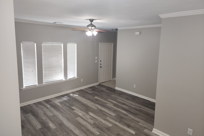 View of Living room and front entry from dining area - Beautiful 3 Bed 3 Bath Townhome Duplex Style For Lease