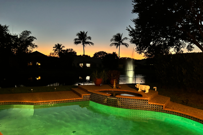 Pool at night - Furnished waterfront home with pool.