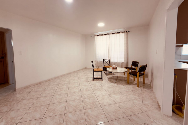 Spacious living room with bright windows - 🏡 Spacious 3BR | 30 mins to Downtown Brooklyn & Manhattan | in Brooklyn Dyker Heights Apartments