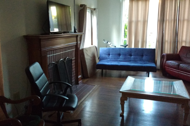 living room - $1k/month to live in large house with big yard and a dog!