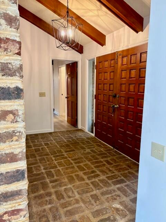 Front Foyer featuring Charleston Brick accent wall - James Island close to downtown, beach and interstate House