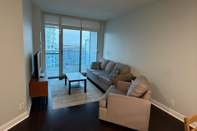 Living Room - Furnished Bedroom in a 2-Bedroom Condo for Rent - Mississauga City Centre