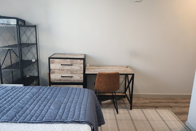 Photo of Bedroom, with provided dresser, chair, and desk visible. - 320 West Mag Apartment 615 Lease Takeover for Spring and Summer Semesters(Jan-July)
