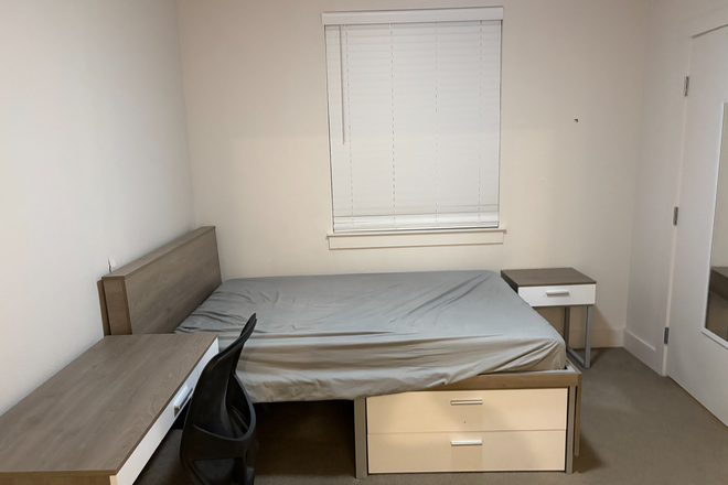 Bedroom with desk, chair, nightstand, and drawers - Park West Apartments