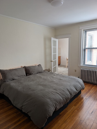 Living space/bedroom with early morning light - Spacious studio steps from Harvard campus, fully furnished, flexible dates May-August Apartments