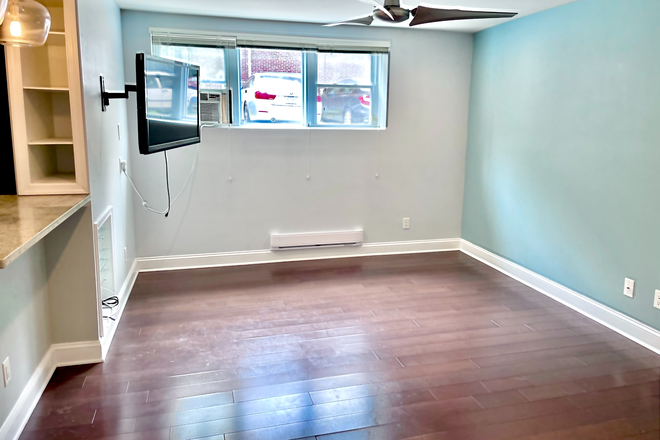 Living room with wall-mounted TV - GLOVER PARK 1BD/1BA — CLOSE TO CAMPUS | Utilities Included | Avail June 1