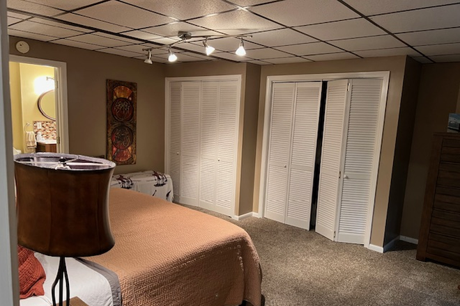 Bedroom (some items may be removed) - Spacious, furnished, private 1-bedrm Basement Apt & Utilities; gym, hot tub access) $1,650 or less