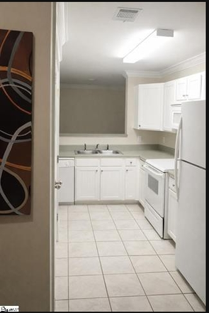 The Kitchen. Includes a microwave, dishwasher, and refrigerator. Also included is a washer and dryer. - Woodlands of Clemson Condo