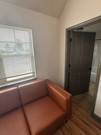 Tiny home living room sofa. - SKIP THE WAITLIST! 1x1 Tiny Home for Re-Let at The Pier