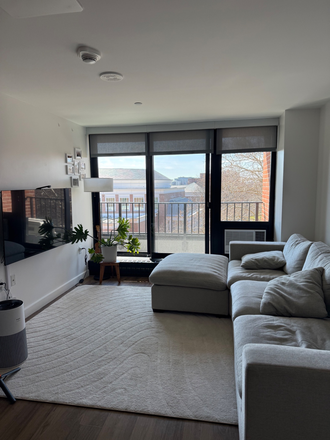 Living room & balcony - 1-Bedroom in Soldiers Field Park 2 Building (Furnished, AC, Dishwasher, In-unit W/D, Gym, Lounge) Apartments