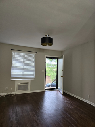 Front door with new storm door - The Villager Condominiums