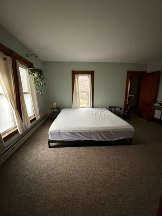 Bedroom with Nectar king mattress and two bedside tables. - *Furnished* Studio Apartment!