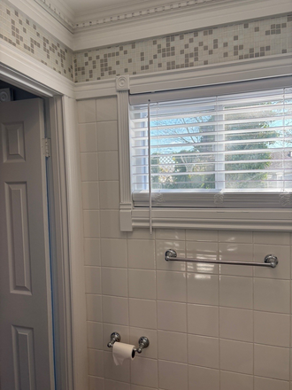 Bathroom window overlooking the private backyard - 1 Bed 1 Bath Apartment with street parking and large private backyard
