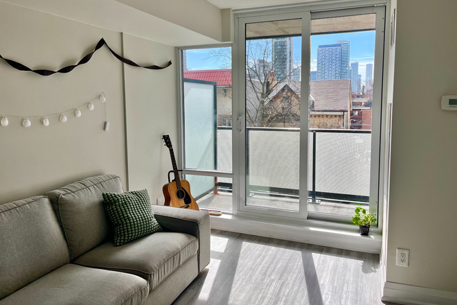 Living room & balcony - Furnished Single Bedroom & Bathroom in shared apartment walkable to St. George campus.