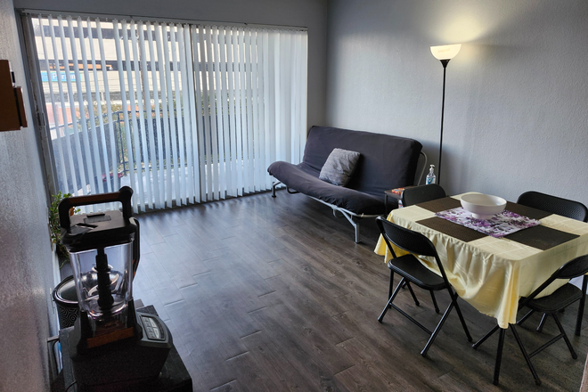 Living Room with View of Balcony - Helix at the District apartment for rent starting January 2026