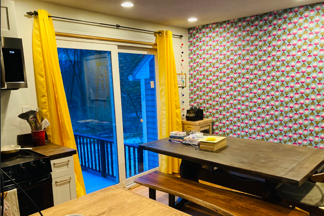 View of the dining room table onto deck - Kid & pet-friendly Amherst home w/garden near bike and hike trails
