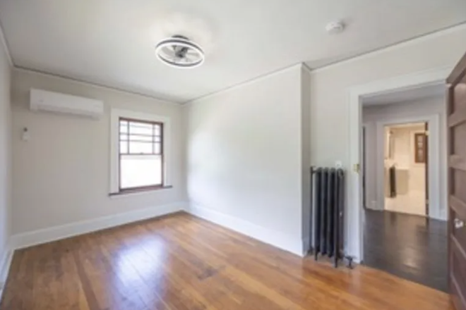 Bedroom for Rent. Includes: Full-Size Bed with Comforter, Table, Chair, Lamp, and Trash Can (not shown in original image) - Beautiful Home in the Heart of Campus