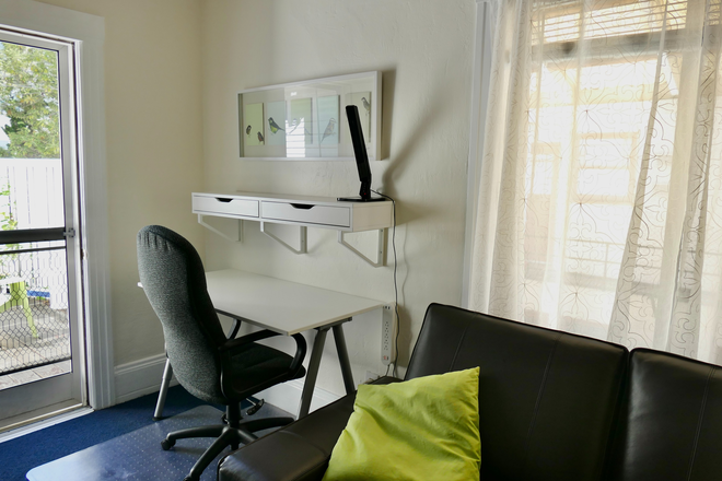 Living room desk and office chair, plenty of natural light - N Berkeley, furnished, walk to campus, bright, LARGE one-bedroom apartment