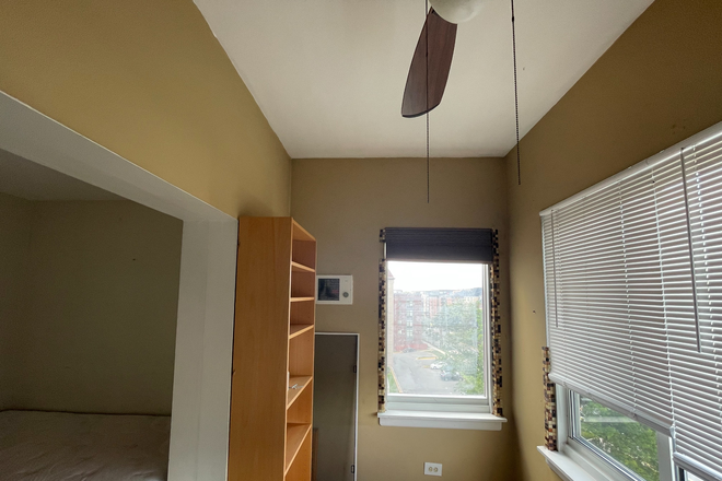 Sunroom area of bedroom, showing furniture and ceiling fan - College Park Towers Apartments