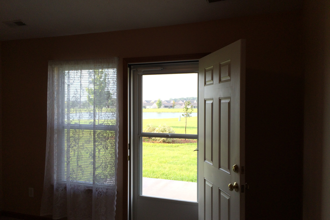 Backdoor opens to yard, landscape, and pond - Lindberg Village Duplex Duplex