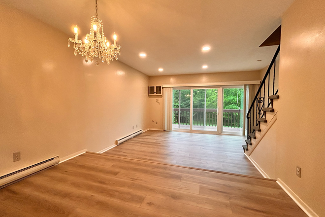 Huge first floor that leads to a sunny deck - HUGE Luxury Renovated Condo – Steps from UConn, Pool + Washer/Dryer