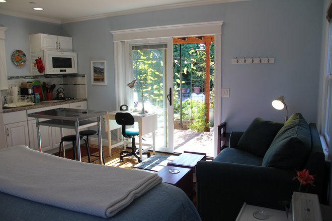 Looking toward deck from corner of bed - PEACEFUL DETACHED BACKYARD COTTAGE ON BERKELEY/OAKLAND BORDER, 3 BLOCKS TO ASHBY BART Rental