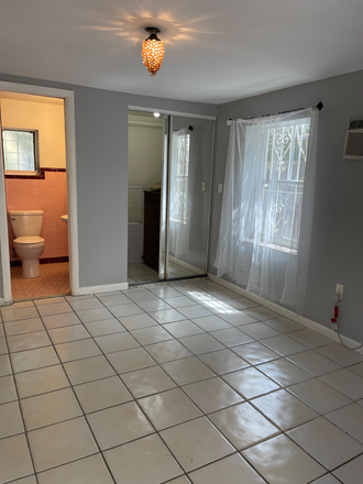 master bedroom with view of bathroom and closet - 2/1 Cottage – 12 Mins to UM, Near Grove, Gables & Brickell