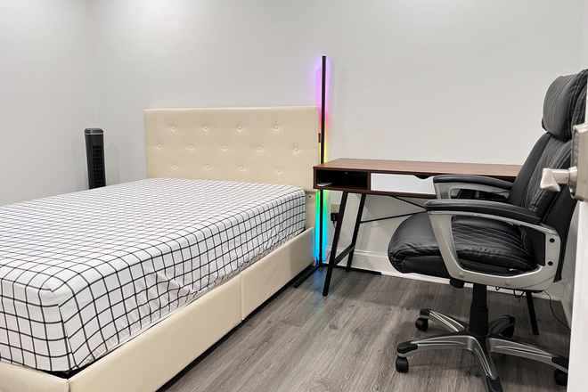 Bedroom showcasing bed, mattress,  tower fan, led lamp, desk, chair - All-inclusive Bedroom for 2026-2027 Lease $0 Application Fee, No other fees.