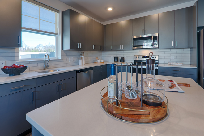 Quartz island, slate-blue cabinetry, stainless Whirlpool appliances. A kitchen that takes cooking seriously. - Unfurished 1BR apt-Forge Circle-Pennington