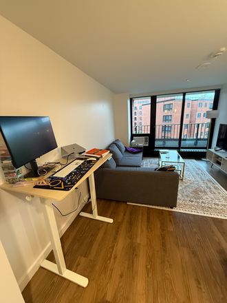 Living room with desk. Balcony is accessible from living room - Modern 1 Bed at 2 Soldiers Field Park