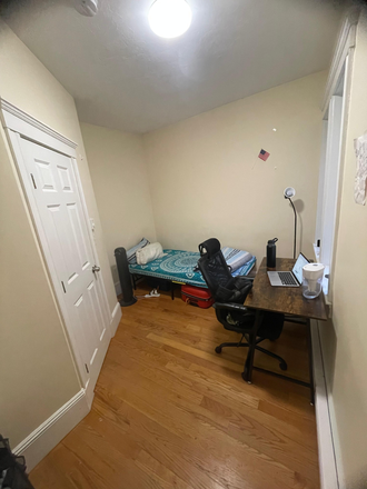 Bedroom with window and a spacious wardrobe. - Apartment