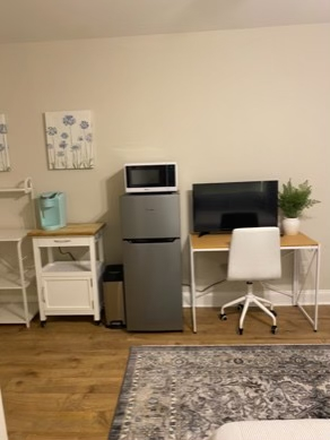 Refrigerator, desk, smart TV and microwave - Nice downtown area efficiency apartment in with private bath and garage