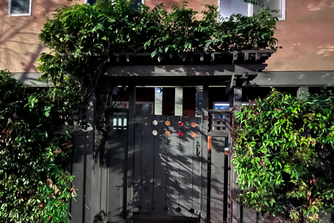 Gate outside apartment complex - Spring sublet: Single + private bathroom at film-loving home