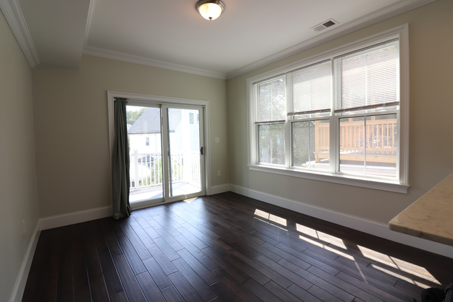 living room - Modern JP 4 bed/2 bath with in unit laundry, AC, and a deck - NO FEE! Apartments