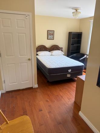 Double bed, bed linen, door to large closet, bookcase - Private Bachelor/Studio Apartment