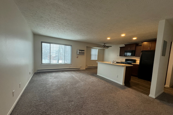 Living-Dining Room - Woodbrook Village Apartments in East Lansing