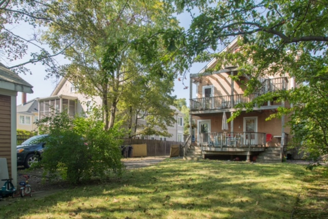 backyard and back of house - Large duplex 1 bedroom overlooking Fresh Pond 1 mile from campus Duplex