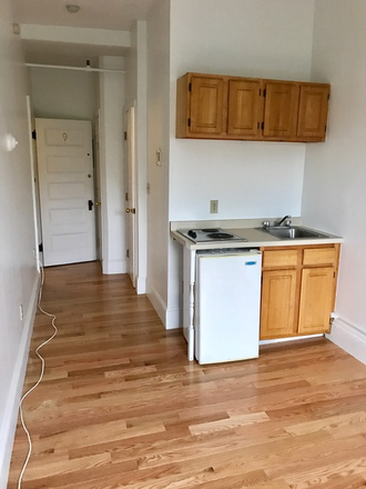 Visit hubrealtyproperties.com - Beautiful studio with a large window, front views and on the green line T Apartments