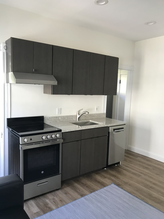 full kitchen - Bright, Garden-level Furnished Studio Rental near Harvard Observatory Duplex