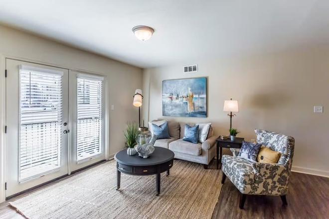 Living room with doors to patio - Rev at 1903... Very spacious 2 bedroom! Looking for a female!